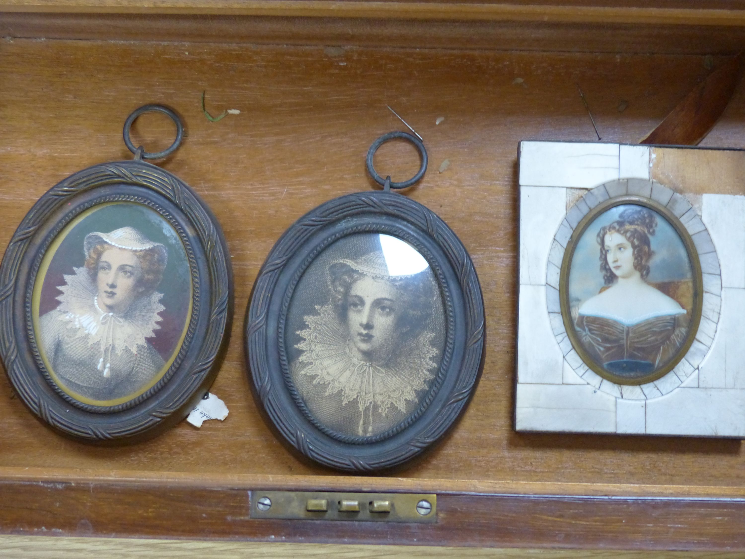 Two brass framed portraits and a portrait miniature and a mahogany writing slope, width 50cm